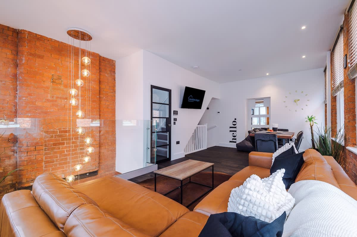 Bright, fully-furnished serviced apartment interior with floor-to-ceiling windows